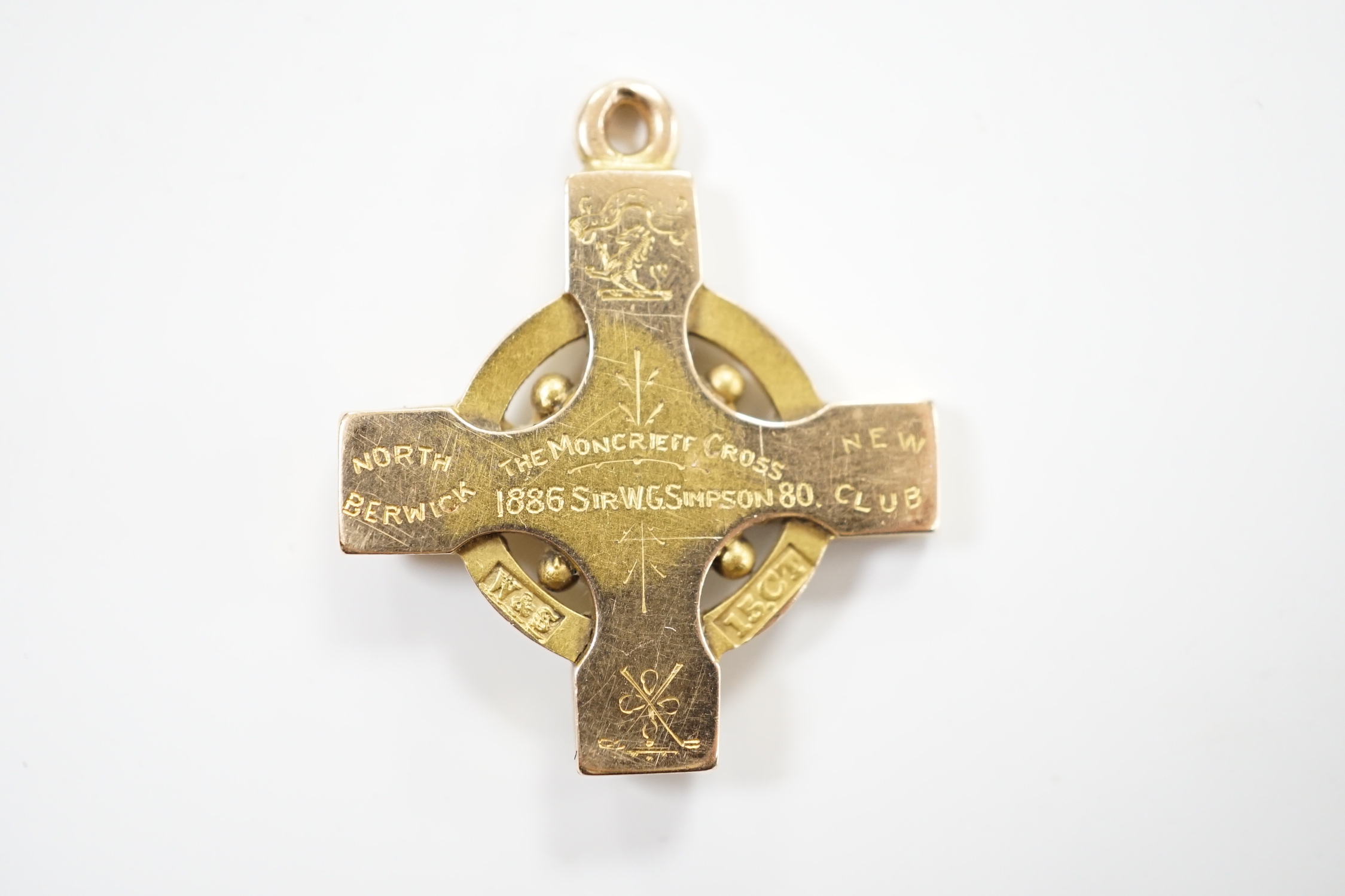 GOLF INTEREST- A late Victorian 15ct pendant with engraved inscription, 'North Berwick New Club, The Moncrieff Cross, awarded to Sir W.G. Simpson 80, 1886', 27mm, 7.1 grams.